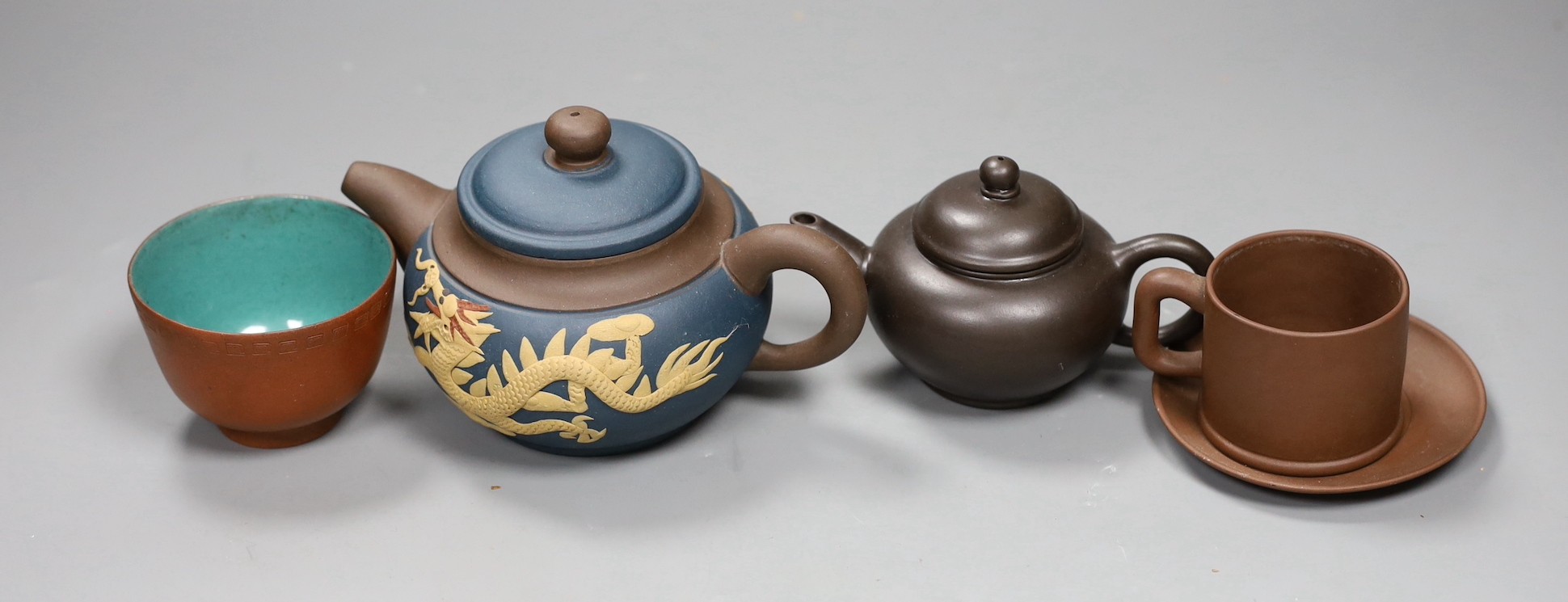 A 19th century Chinese Yixing cup, two later teapots and a cup and saucer